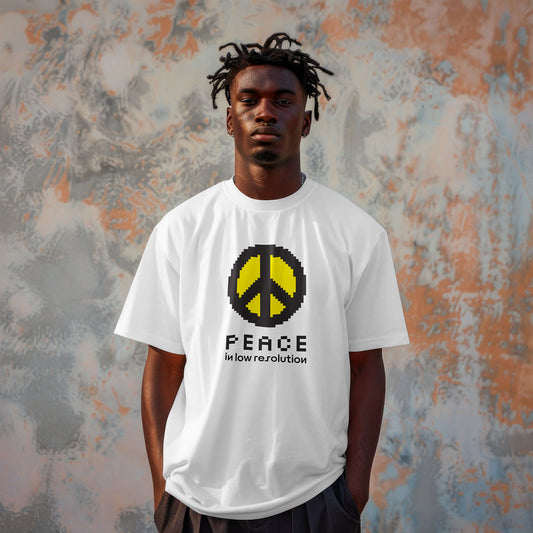 Person wearing a white oversized t-shirt with a black-yellow peace symbol design against a textured wall.