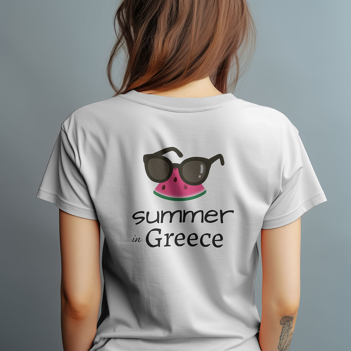 Woman wearing a 'Summer in Greece' t-shirt with sunglasses and watermelon design on the back.