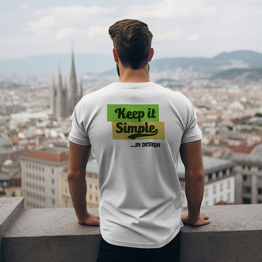 Person wearing a white t-shirt with a green and yellow graphic and text, standing on a rooftop with a cityscape view. Back side printing